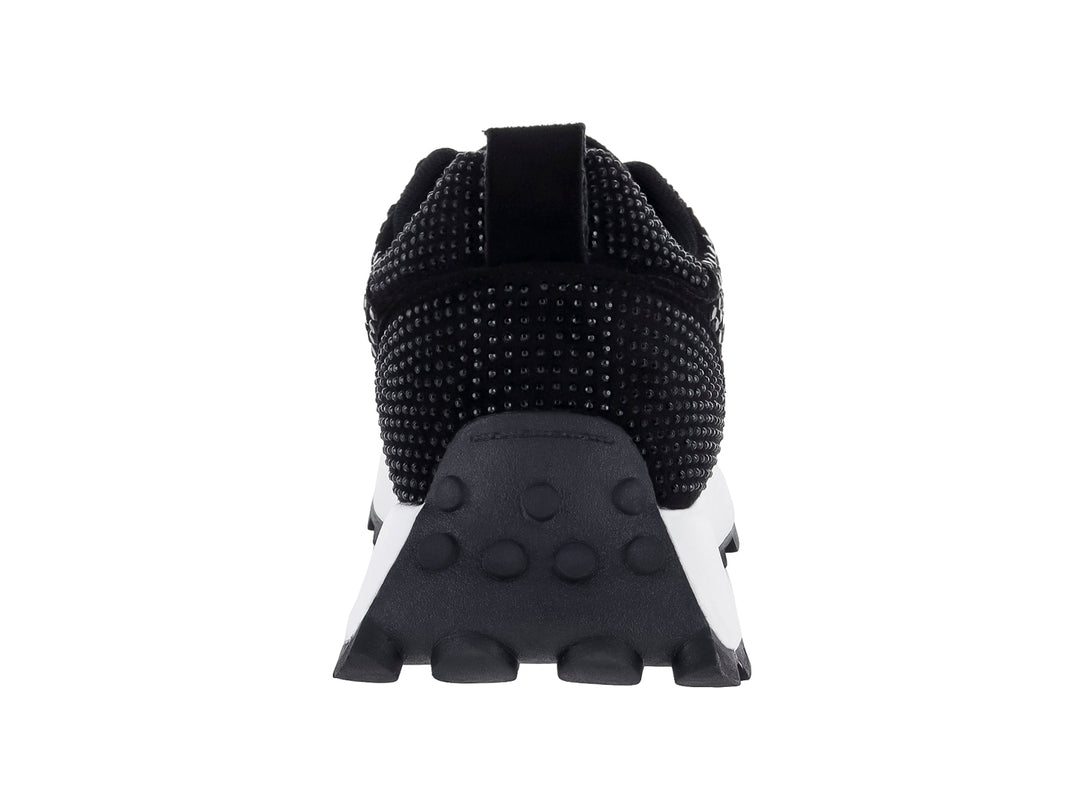 Tenis negros para mujer con detalles de pedrería brillante y suela blanca dentada.