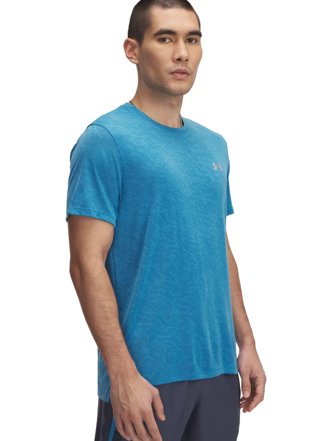 Hombre vistiendo una camiseta deportiva de manga corta color azul de la marca Under Armour.