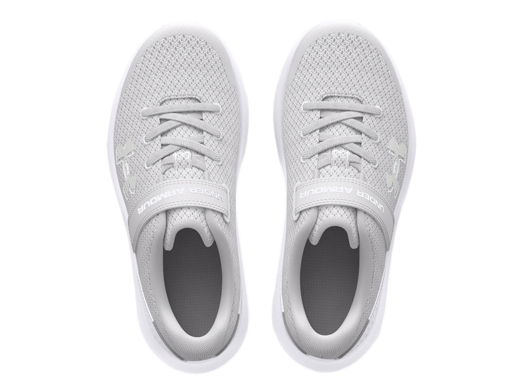 Tenis deportivos Under Armour color gris con suela blanca y correa de ajuste.