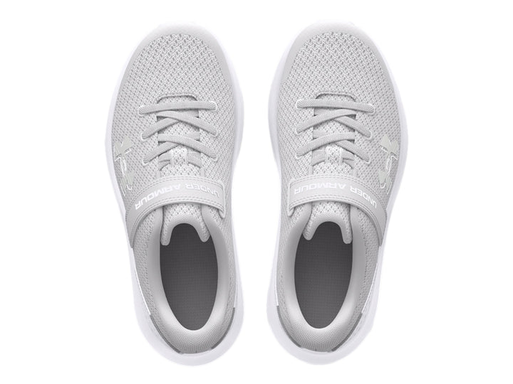 Tenis deportivos Under Armour color gris con suela blanca y correa de ajuste.