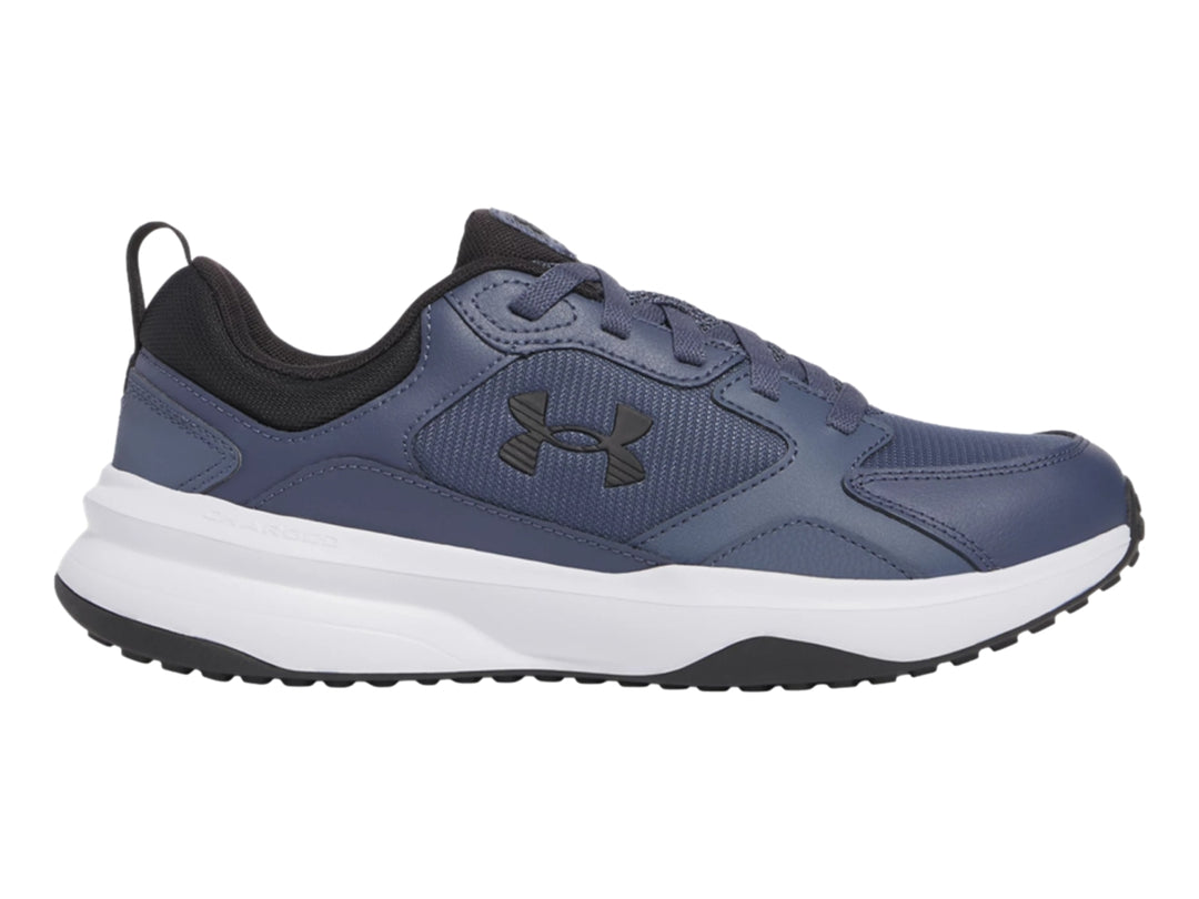 Tenis deportivos Under Armour color gris con suela blanca y detalles negros.