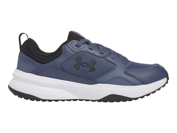 Tenis deportivos Under Armour color gris con suela blanca y detalles negros.