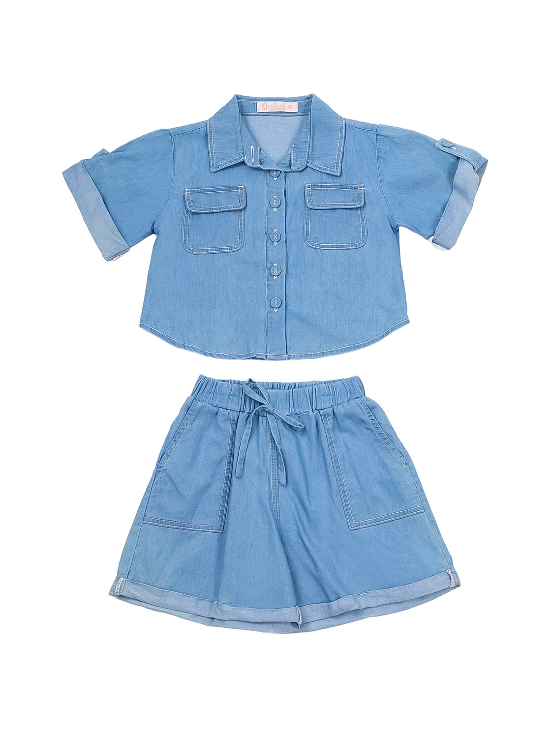 Niña vistiendo un conjunto de dos piezas en color azul claro compuesto por camisa y shorts.