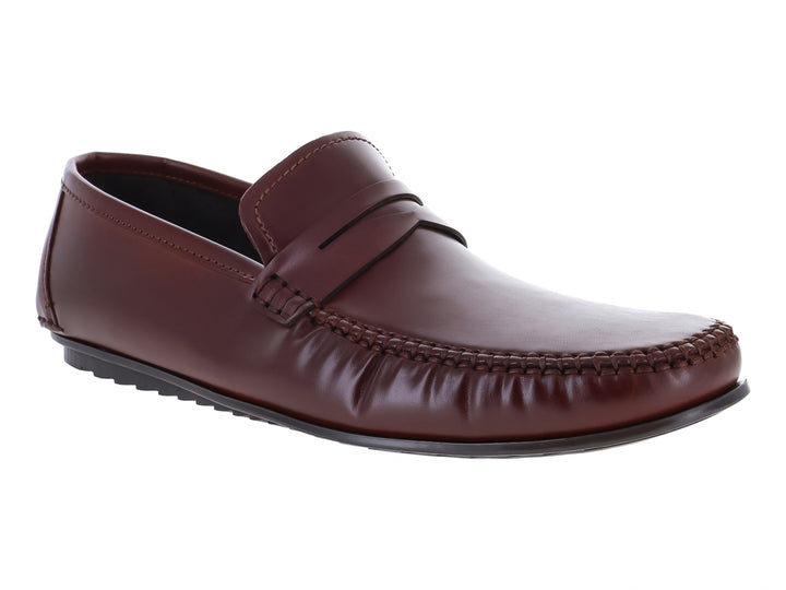 Zapato mocasín de cuero color marrón con suela negra y acabado brillante.