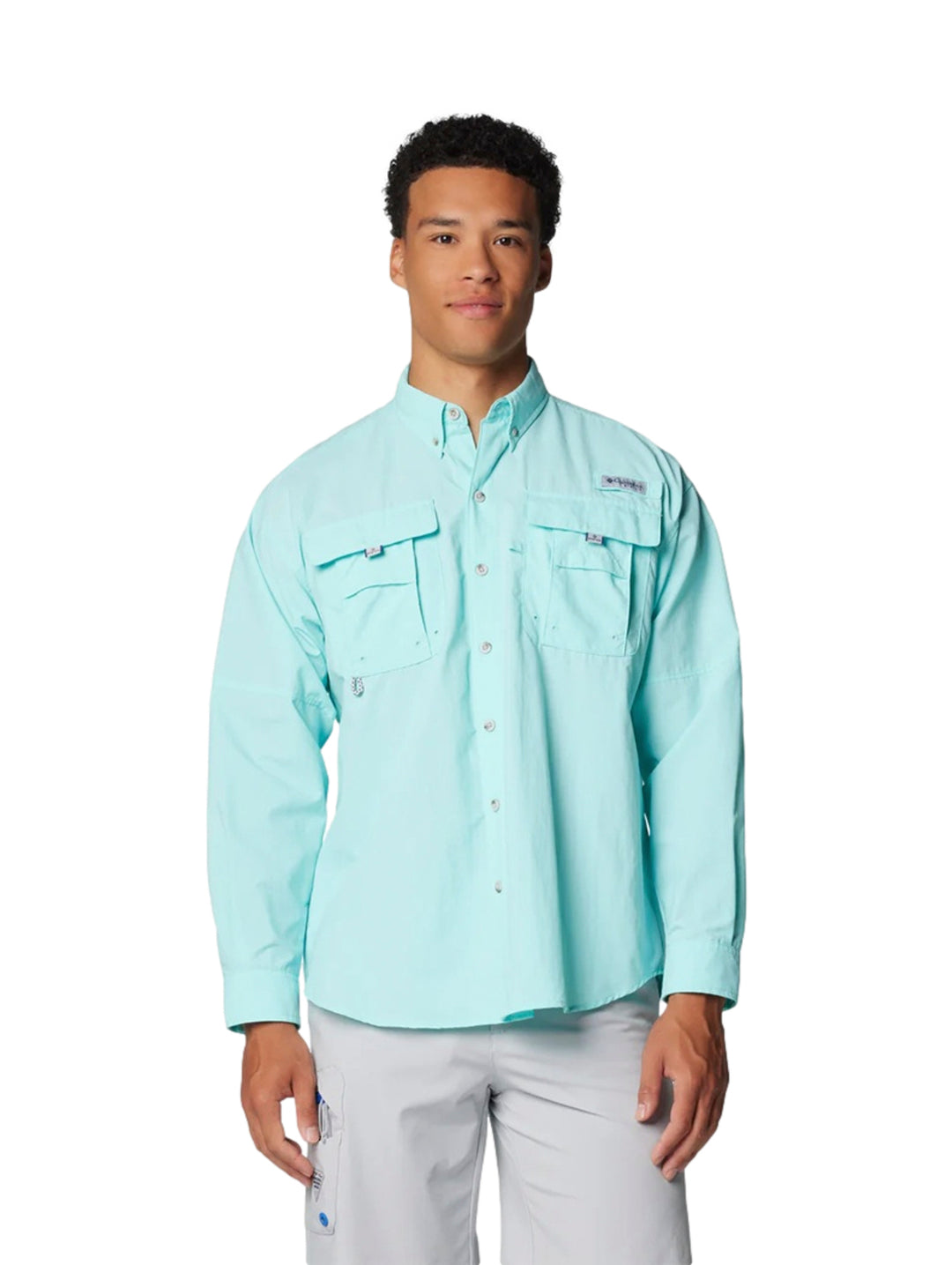 Hombre vistiendo una camisa Columbia PFG de manga larga en color azul claro Gulf Stream con bolsillos frontales.