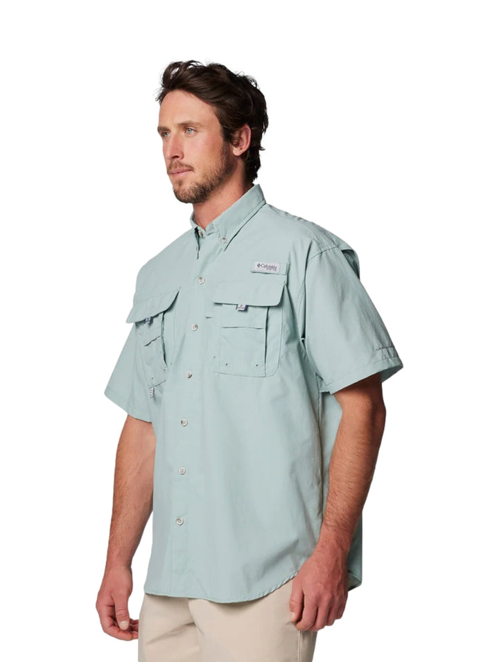 Hombre vistiendo camisa Columbia PFG Bahama II de manga corta en color azul claro con bolsillos frontales.