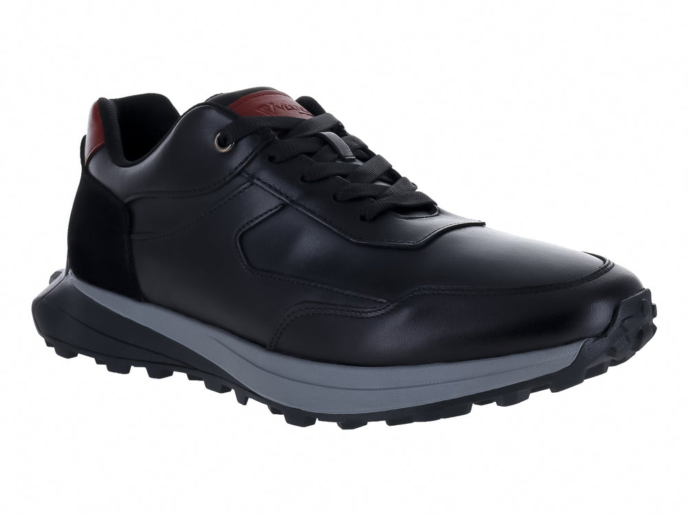 Tenis deportivos color negro con detalles en rojo y suela gris, vista lateral.