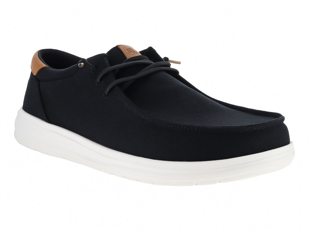 Zapato casual Hey Dude Paul de lona color negro con suela blanca y detalle café en el talón.