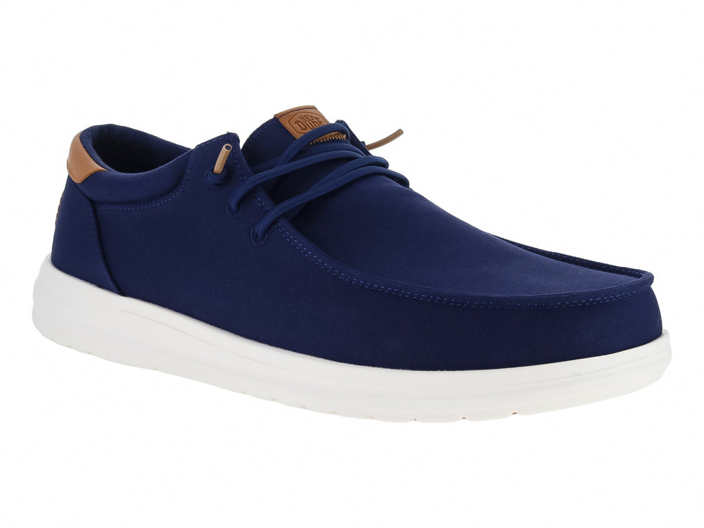 Zapato casual Hey Dude color azul marino con suela blanca y detalles en café.
