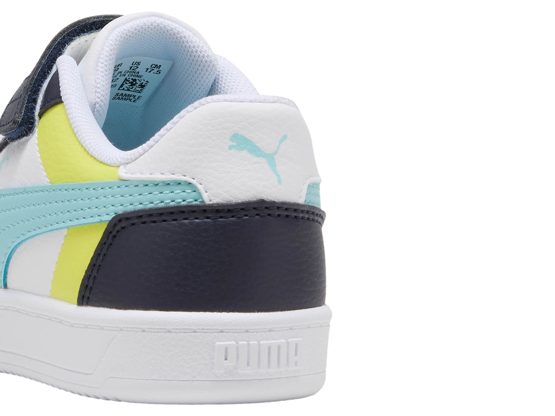 Tenis PUMA infantiles en colores blanco y azul marino con detalles en amarillo y celeste, con correa y cordones.