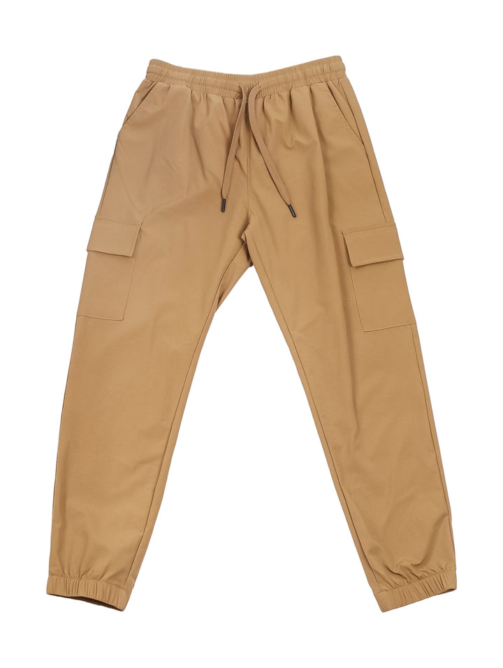 Hombre vistiendo pantalones jogger color beige con cintura ajustable y puños elásticos.
