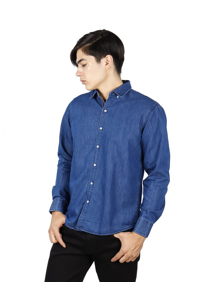 Hombre vistiendo una camisa azul de manga larga estilo denim con botones frontales.