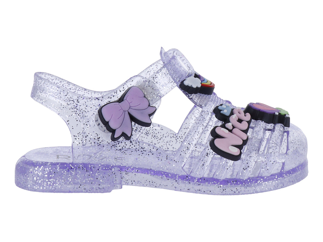 Sandalias infantiles color morado con glitter, decoradas con un moño y letras que dicen &