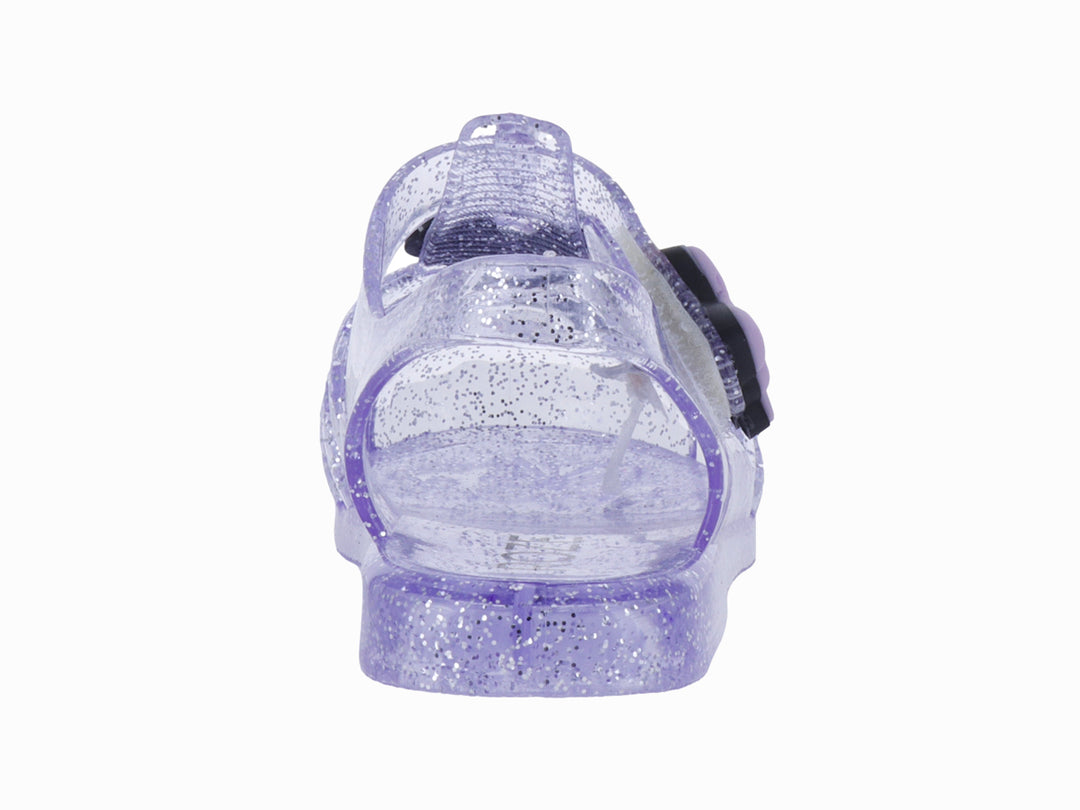 Sandalias infantiles color morado con glitter, decoradas con un moño y letras que dicen &