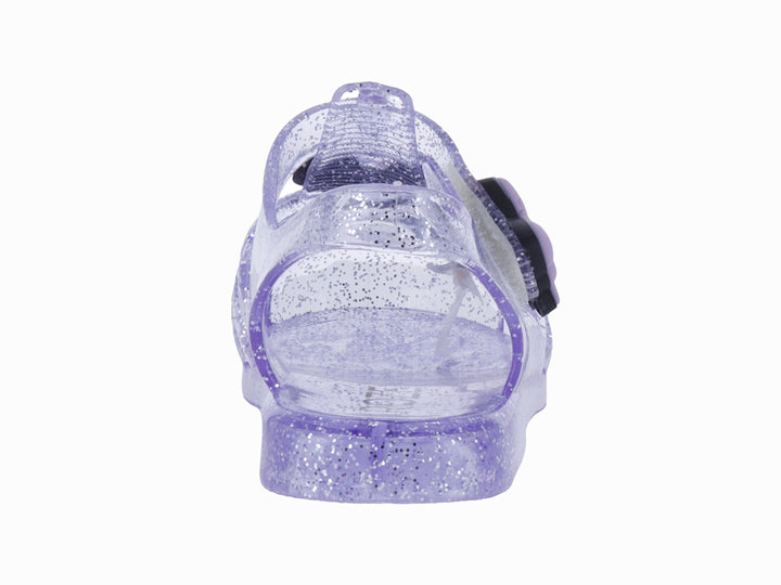 Sandalias infantiles color morado con glitter, decoradas con un moño y letras que dicen &