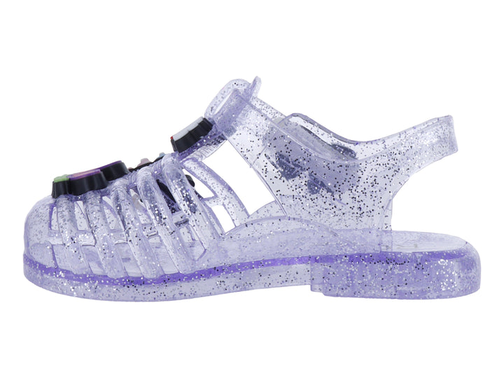 Sandalias infantiles color morado con glitter, decoradas con un moño y letras que dicen &
