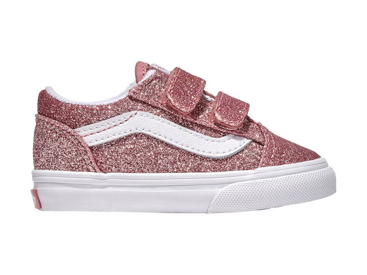 Tenis Vans Old Skool color rosa dorado con glitter, suela blanca y cierres de velcro.
