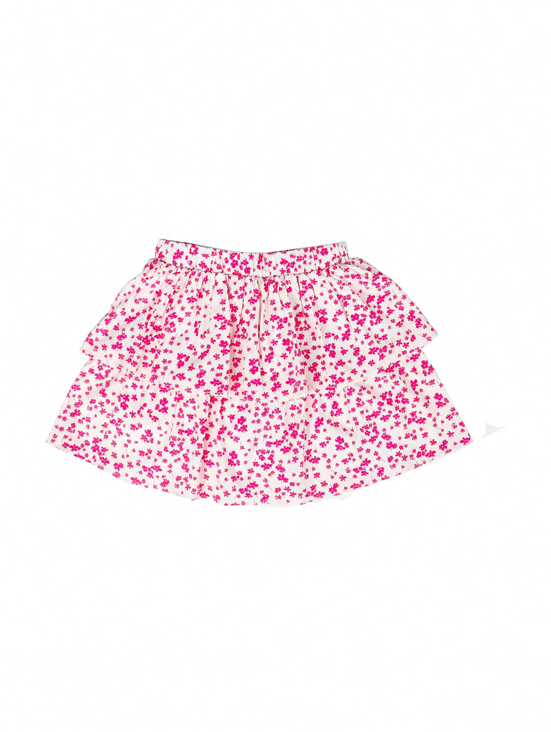 Falda corta para niña en color blanco con estampado de flores rosas y diseño de volantes.