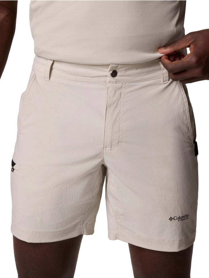 Hombre vistiendo pantalones cortos Columbia color Dark Stone de estilo ligero y deportivo.
