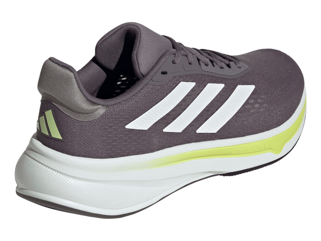 Tenis Adidas Response Super color gris con suela blanca y detalles en verde lima.