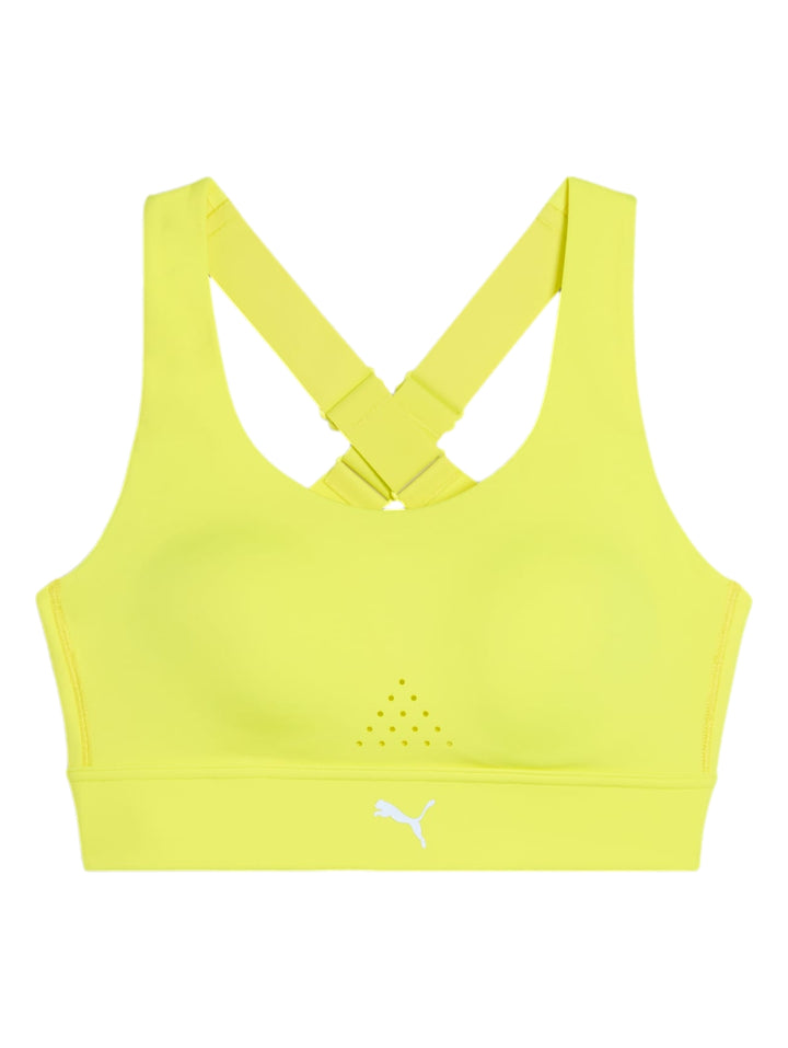 Top deportivo PUMA color amarillo limón usado por una mujer.
