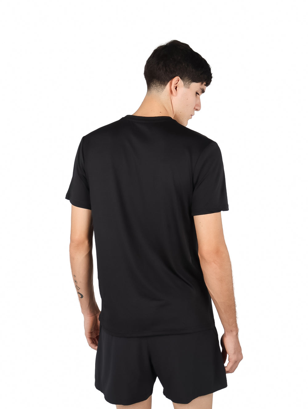Hombre vistiendo una playera deportiva de manga corta color negro sobre fondo blanco.