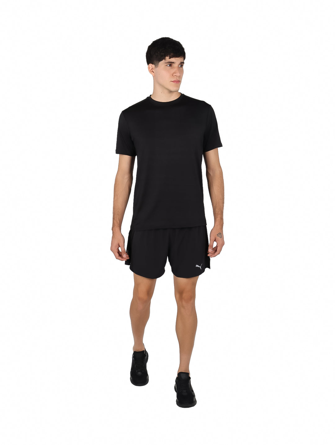 Hombre vistiendo una playera deportiva de manga corta color negro sobre fondo blanco.
