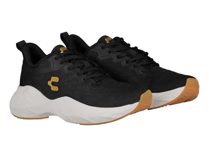 Tenis deportivos Charly color negro con suela blanca y logotipo dorado.
