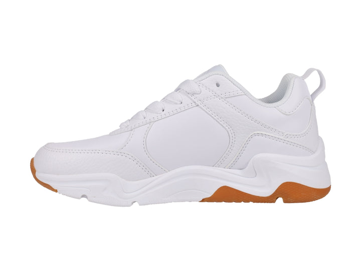 Tenis Champion blancos con suela de goma color café, diseño deportivo y moderno.