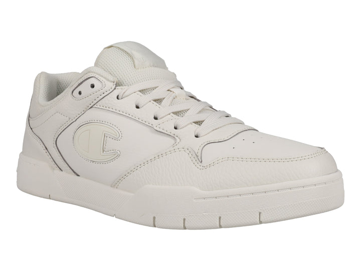 Tenis Champion color hueso, diseño deportivo de corte bajo con logo lateral.