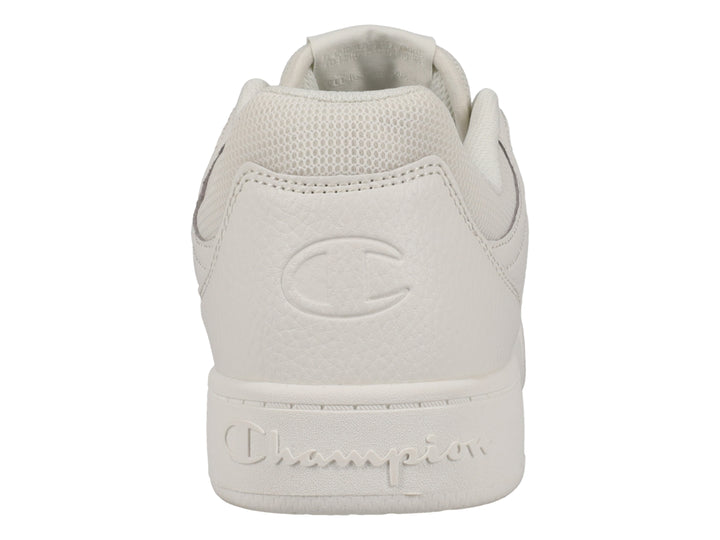 Tenis Champion color hueso, diseño deportivo de corte bajo con logo lateral.