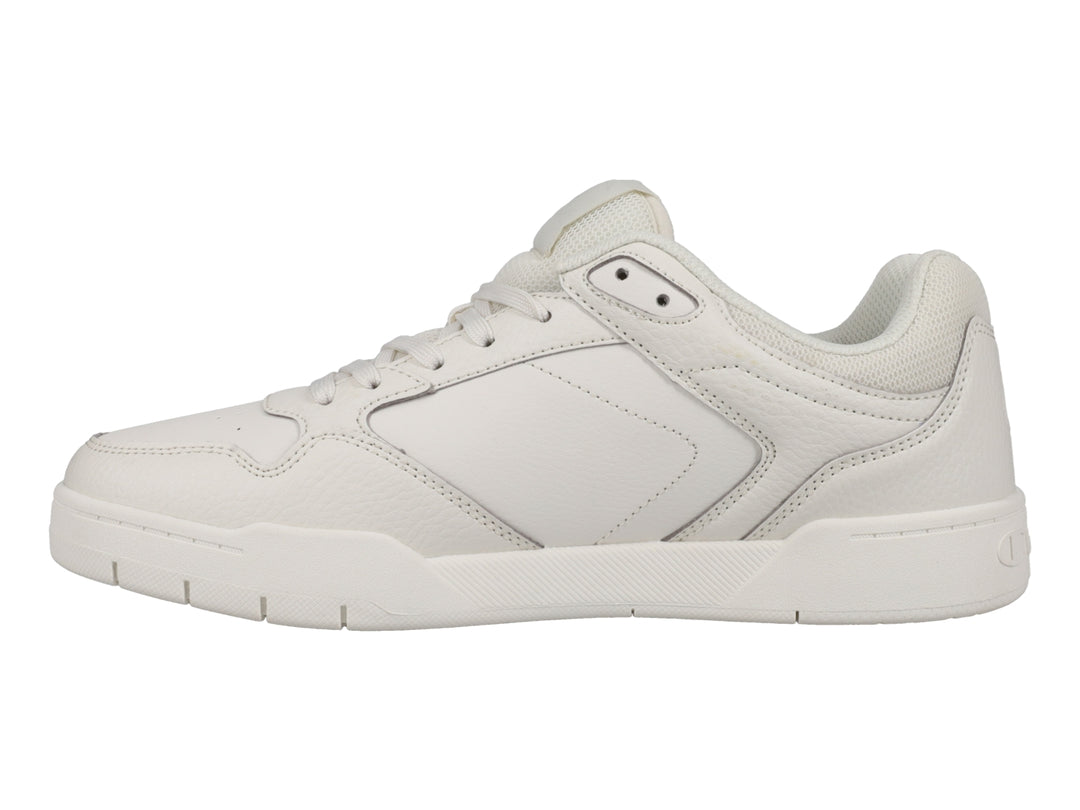 Tenis Champion color hueso, diseño deportivo de corte bajo con logo lateral.