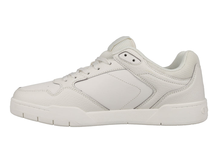 Tenis Champion color hueso, diseño deportivo de corte bajo con logo lateral.