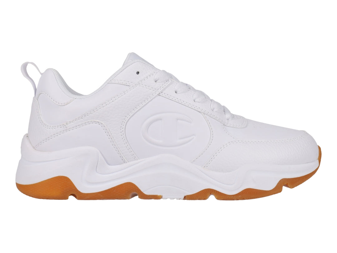 Tenis Champion blancos con suela de goma color caramelo y diseño deportivo.