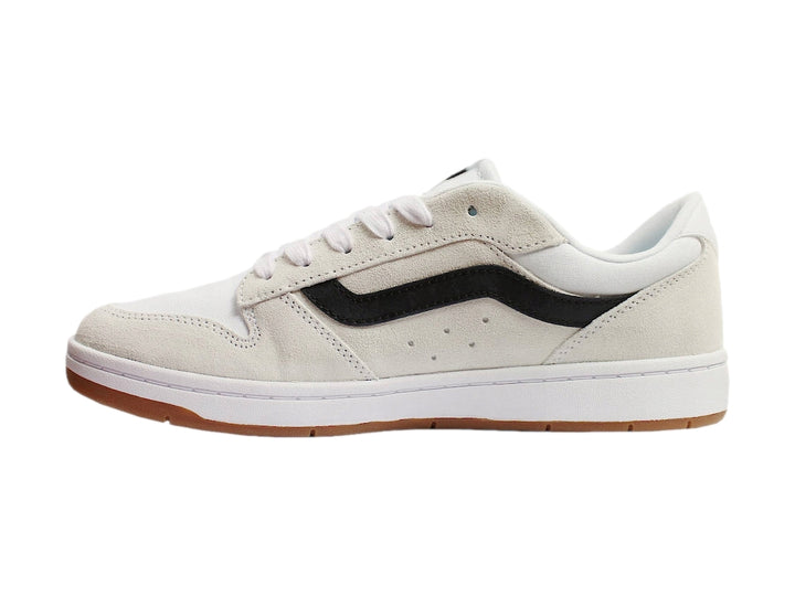 Tenis Vans blancos con franja lateral negra y suela de goma color miel.