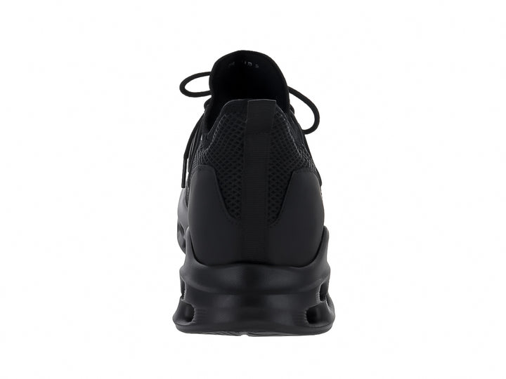 Tenis deportivos Andrax color negro con suela gruesa perforada y tejido de malla.