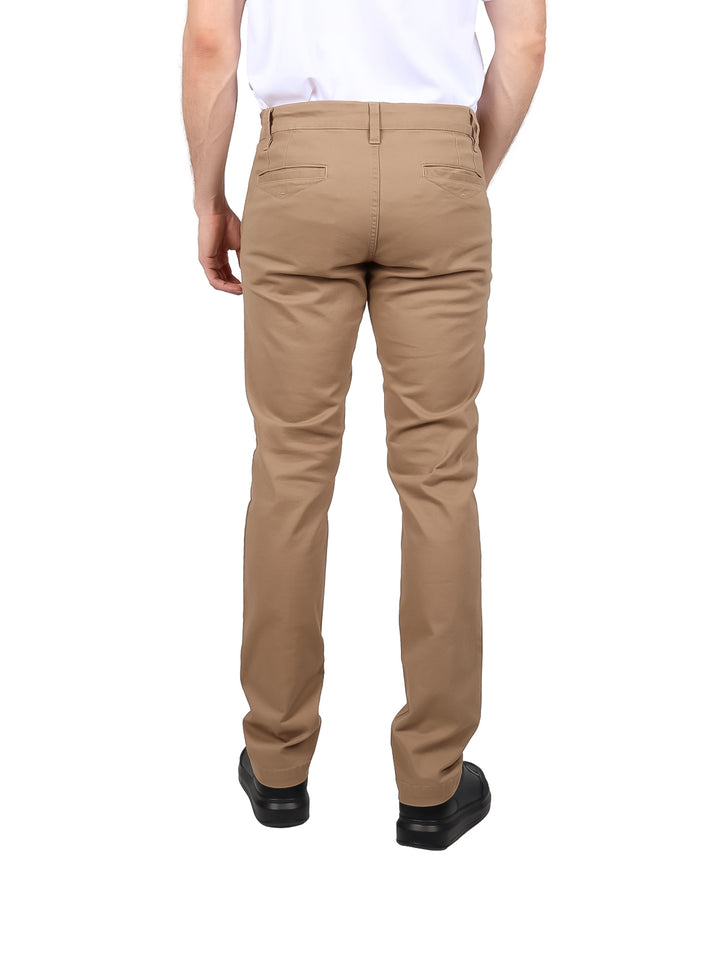 Hombre vistiendo un pantalón casual color beige de corte recto.