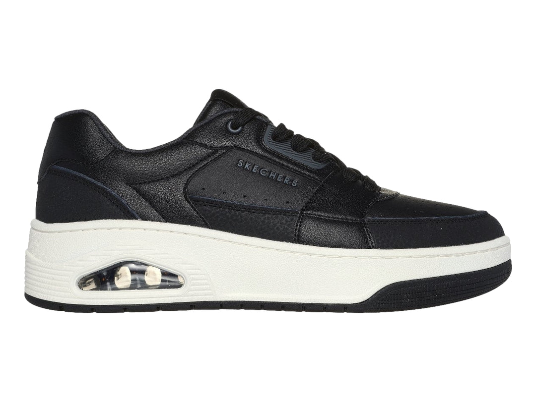 Tenis Skechers color negro con suela blanca gruesa y detalle en turquesa en el talón.