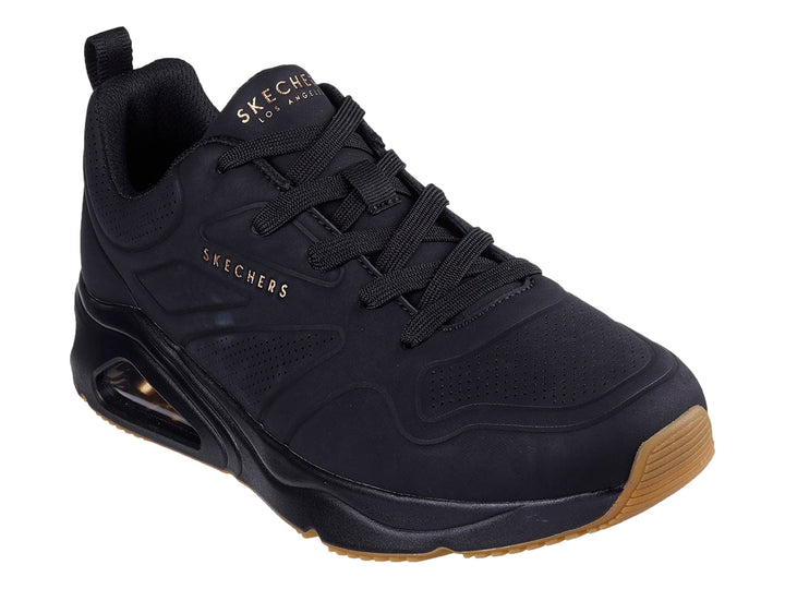 Tenis Skechers negros para hombre con cámara de aire visible en la suela y base color café.