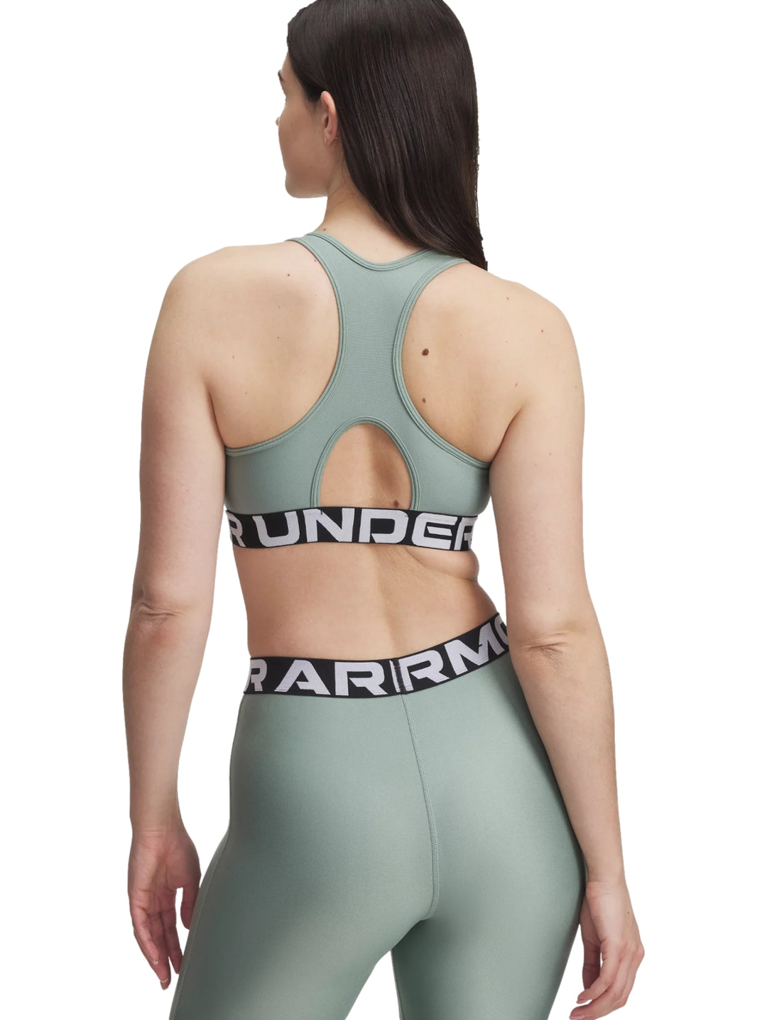 Conjunto deportivo Under Armour de color verde brillante compuesto por un top y leggings con banda elástica logotipada.