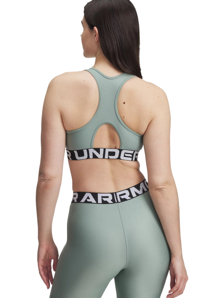 Conjunto deportivo Under Armour de color verde brillante compuesto por un top y leggings con banda elástica logotipada.