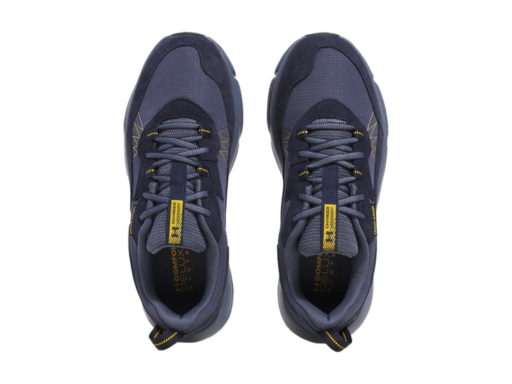 Tenis deportivos Under Armour color azul marino con detalles amarillos y suela gris.
