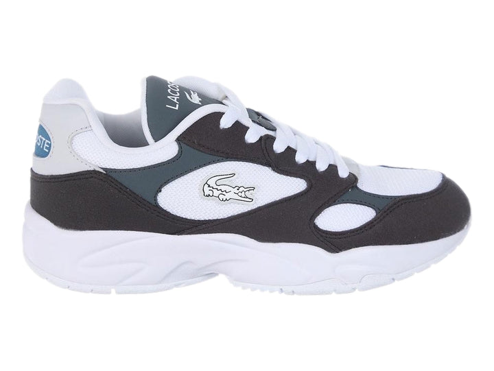 Tenis deportivos Lacoste en colores blanco, negro y gris oscuro con suela blanca gruesa.
