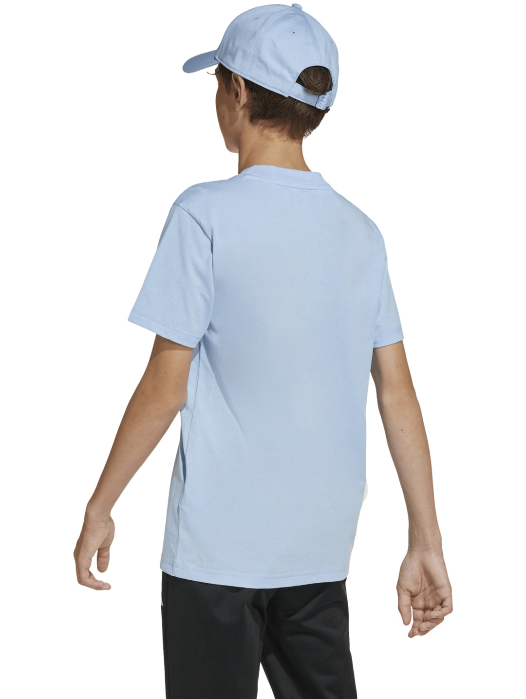 Niño vistiendo playera Adidas azul claro con detalles blancos y pantalones negros.