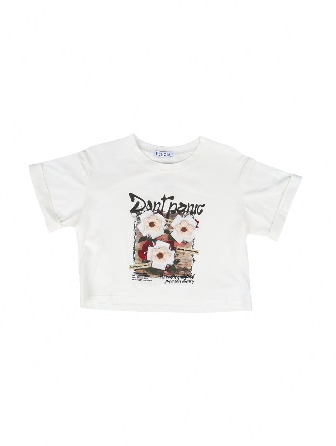 Blusa color ivory para niña con estampado floral y texto 'Don't panic' en el centro.