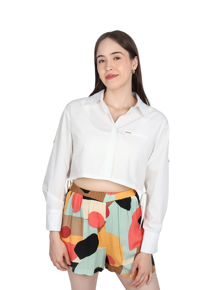 Mujer vistiendo una camisa blanca corta de manga larga con cuello.