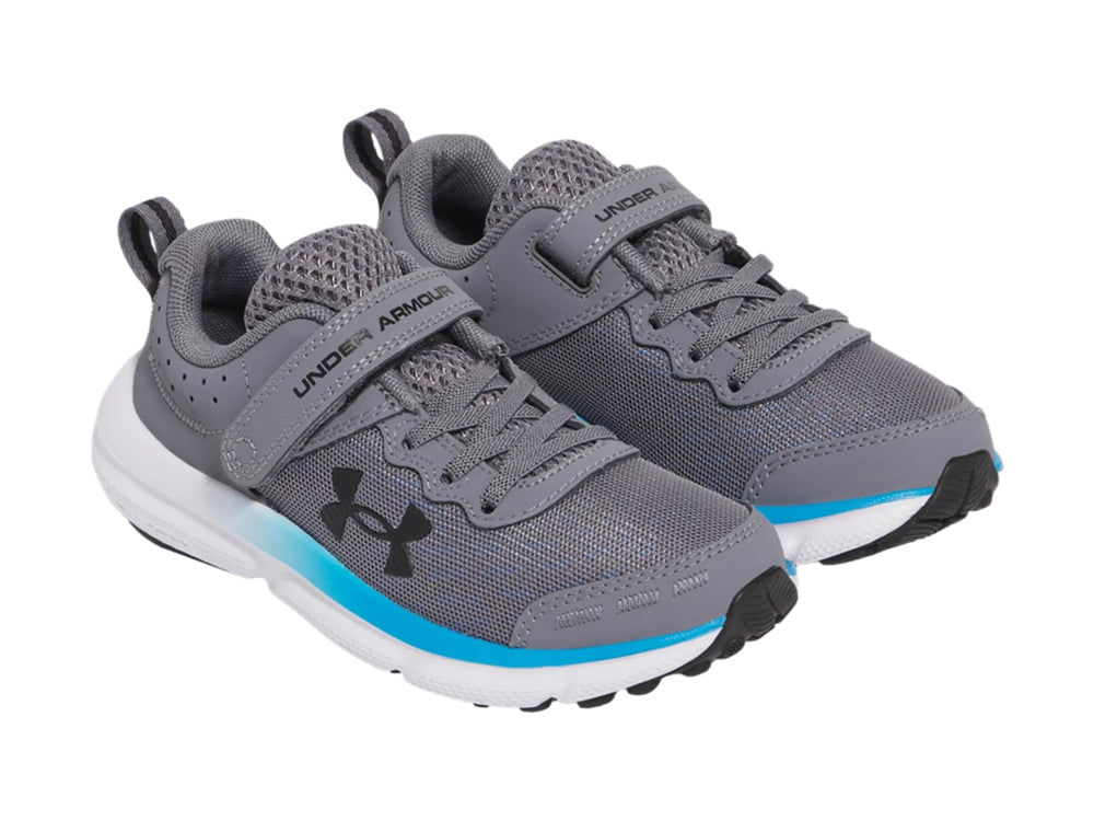 Tenis deportivos Under Armour color gris con suela blanca y detalle azul, cierre de velcro.