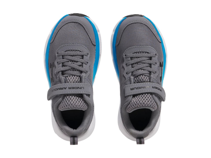 Tenis deportivos Under Armour color gris con suela blanca y detalle azul, cierre de velcro.