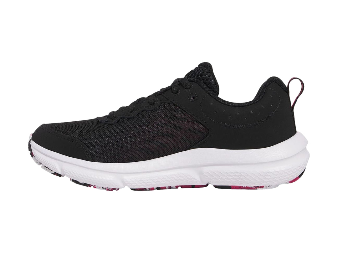 Tenis deportivos Under Armour color negro con suela blanca y detalles en rosa.