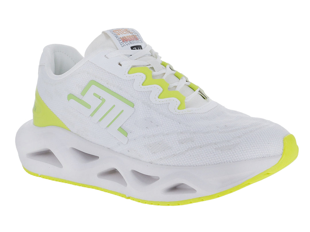 Tenis deportivos Steve Madden color blanco con detalles en lima y suela blanca con diseño hueco.